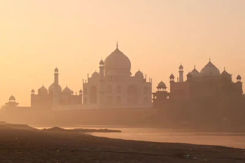 The Taj Mahal in warm misty light at sunrise, Agra