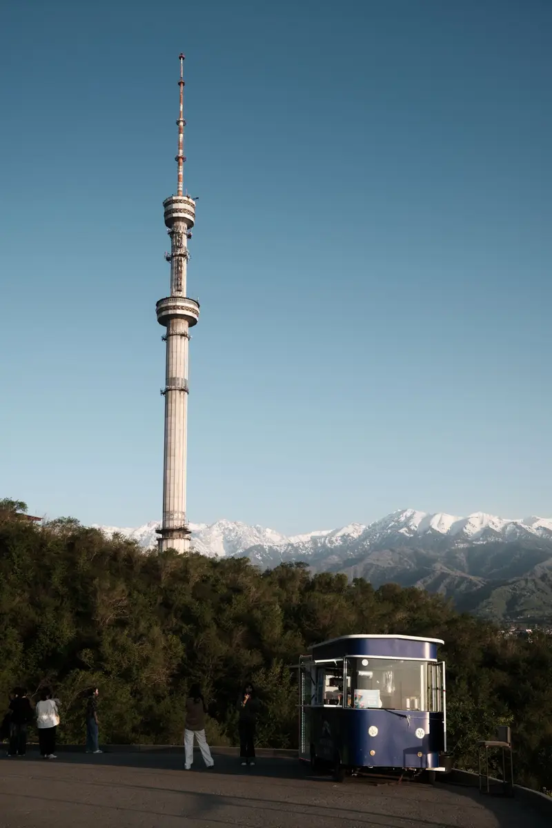 Kok Tobe TV tower in Almaty with the snow-capped Trans-Ili Alatau mountains behind
