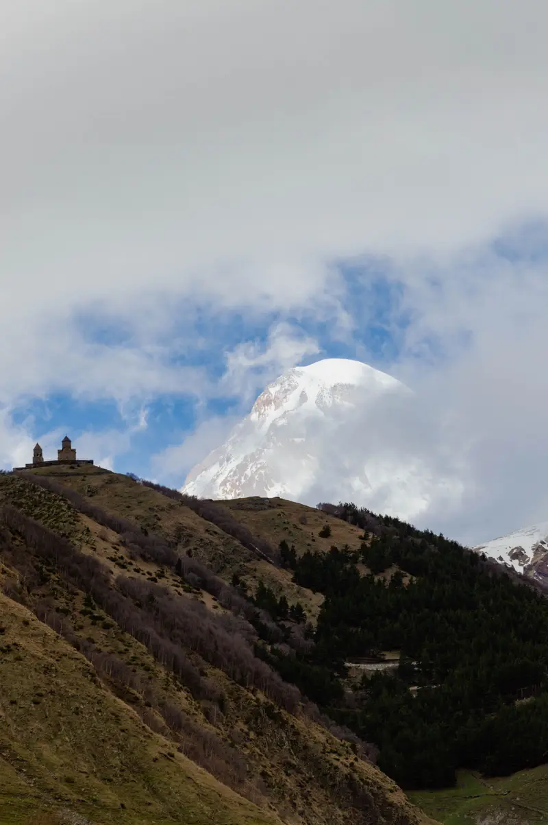 Gergeti Trinity Church below snow-capped Mount Kazbek, Georgia
